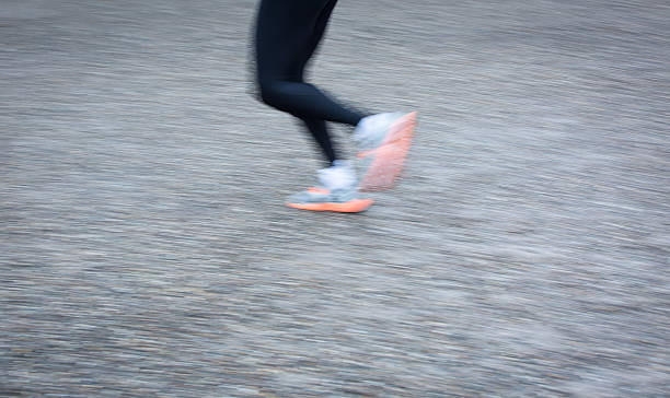 istock Motion blurred runner's feet in a city 185640793