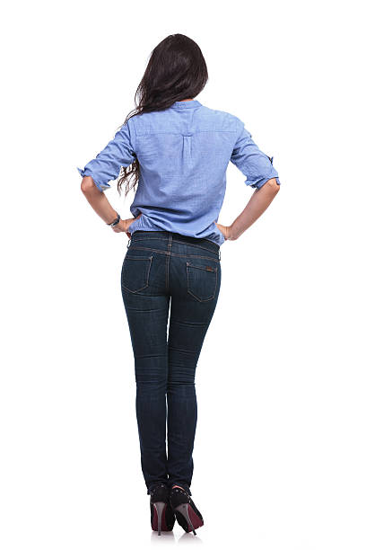 istock back of a casual woman with hands on hips 185641314