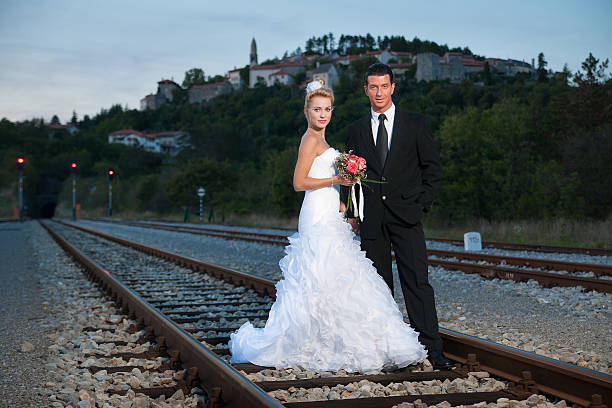 istock Bride and groom on a railway at dusk 185643492