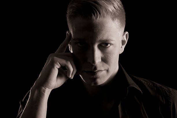 istock Black and white portrait of young confident man, low key. 185643575