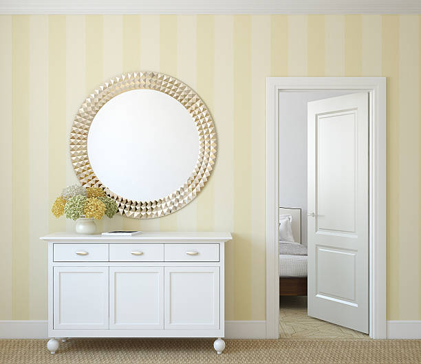 istock Sideboard and mirror in yellow hallway with open door 185644523