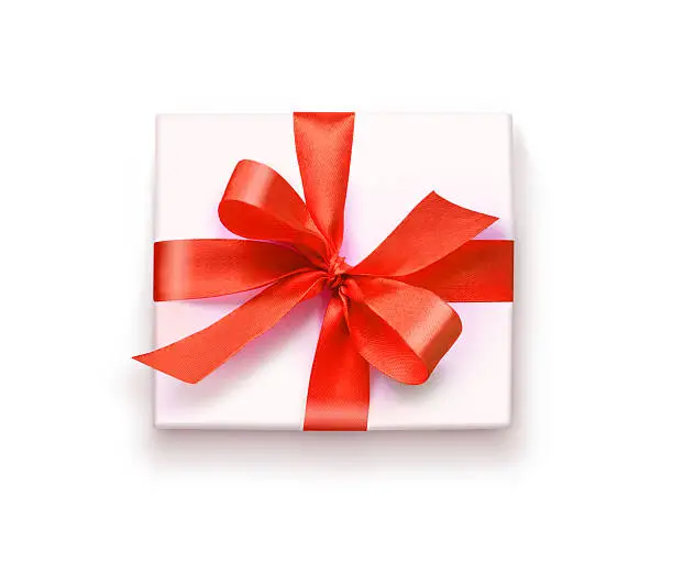 White gift box with red ribbon and bow, isolated on white background