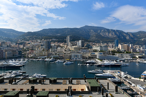 Monaco (France) - The wide panorama of La Condamine and Monte Carlo quarters as well as mediterranean Port Hercule and surrounding french mountains