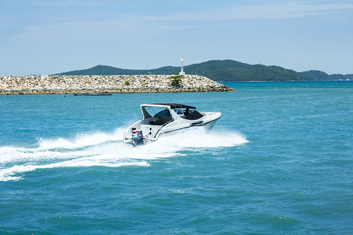 Young man riding jet boat on a summer day at the lake.