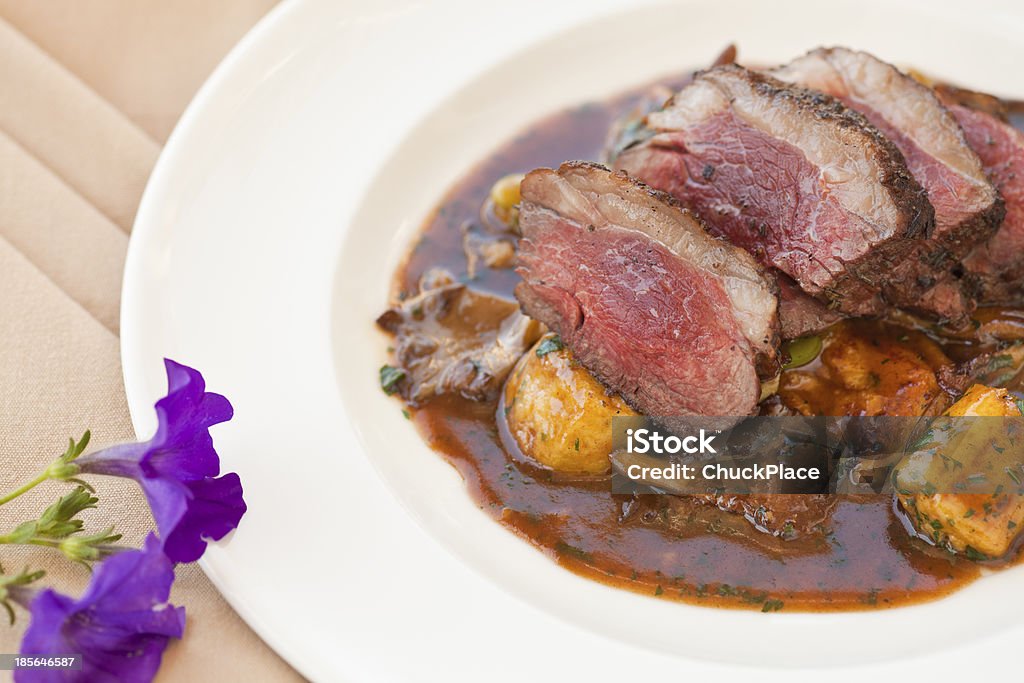 lamb sirloin with herbed gnocchi Brown Stock Photo