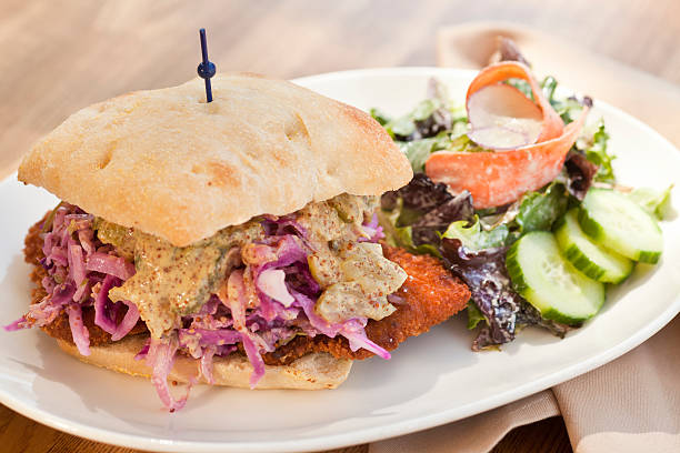 pork sandwich topped with slaw and mustard