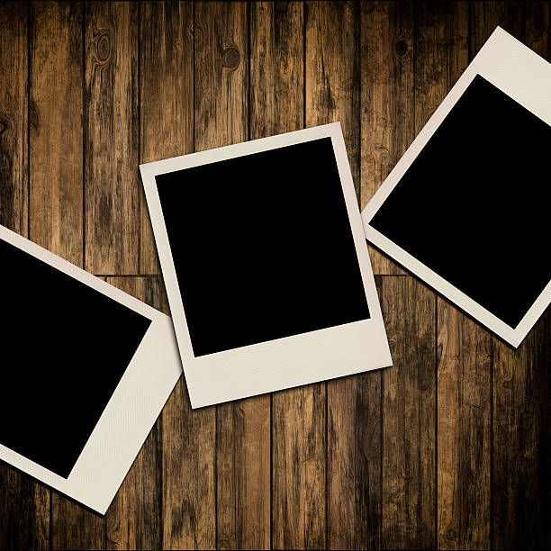 istock Blank instant photo frames on old wooden background 185648655