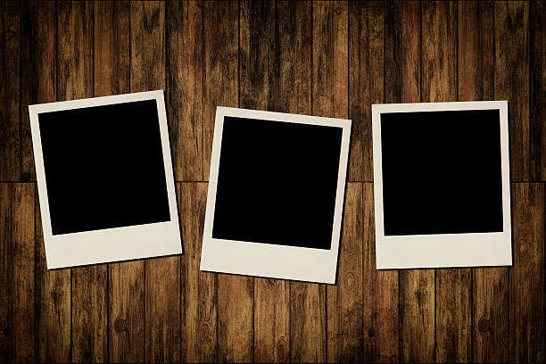 istock Blank instant photo frames on old wooden background 185648662