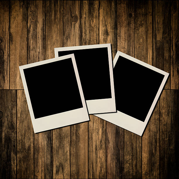 istock Blank instant photo frames on old wooden background 185648751