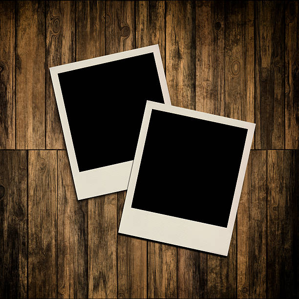 istock Blank instant photo frames on old wooden background 185648777