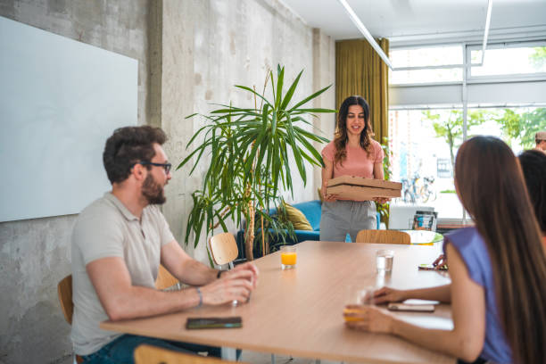 istock Mid Adult Office Lunch Break with Pizza 1856496430