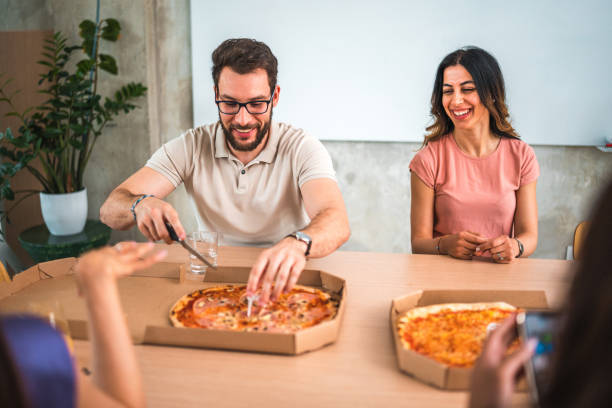 istock Office Team Enjoying Pizza Together 1856496993