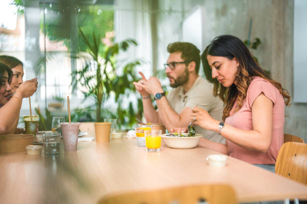 istock Diverse Coworkers Enjoying Health Bowls at Work 1856497488