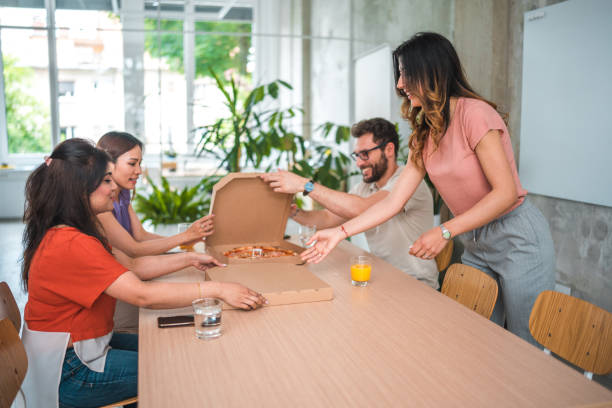 istock Dynamic Office Lunch with Diverse Colleagues and Pizza 1856497496
