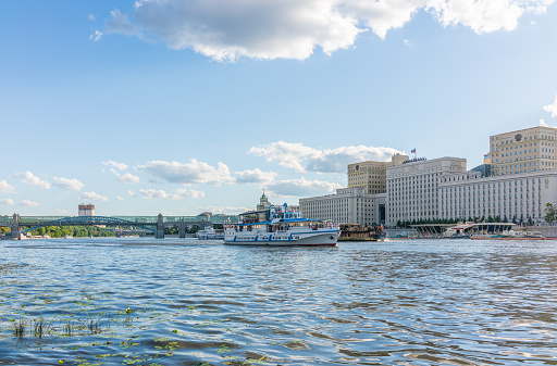Moscow, Russia - July 30, 2022: View of the Ministry of Defence of Russian Federation, and Moscow river embakment. Translation of the inscription on the facade - Ministry of Defense of the Russian Federation