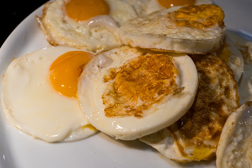 Many fried egg in array line at buffet food in the morning at hotel