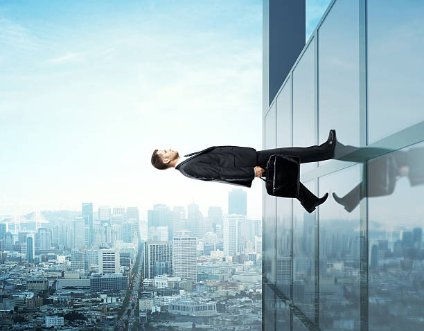 istock Businessman holding a briefcase walking up a building 185663746
