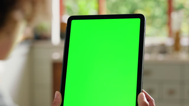 Hands of person, tablet and green screen mockup space in home, online search or communication. Digital technology, chroma key closeup or watch video on display notification, info or social media app