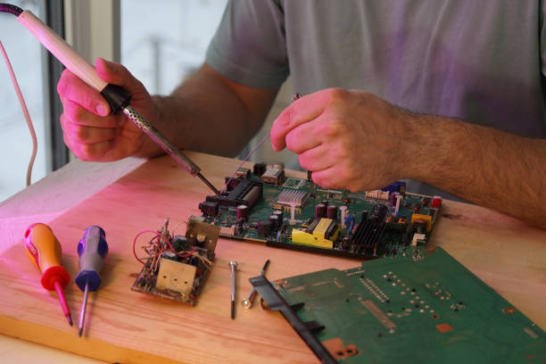 istock A man holds a soldering iron in his hand and solders a microcircuit 1856659114