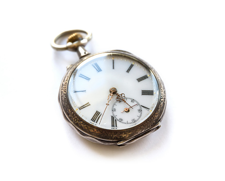 Vintage Pocket watch with shadow isolated on white background. Concept of direction and orientation