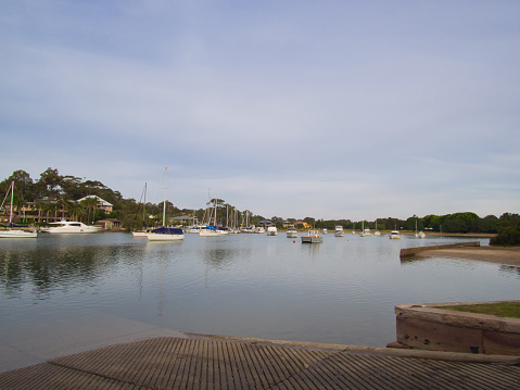 Rowland Reserve, Sydney, Australia - May 24 2019 : Looking from the boat ramp itself, boats and yachts are moored in the safety of an inlet on a cool afternoon.