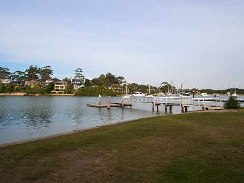 Rowland Reserve, Sydney, Australia - May 24 2019 : Situated in the suburb of Bayview, this reserve is equipped with its own jetty whilst boats are moored in the inlet amongst huge houses.