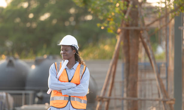 istock At the building site, a female engineer holds a blueprint in hand. 1856753698