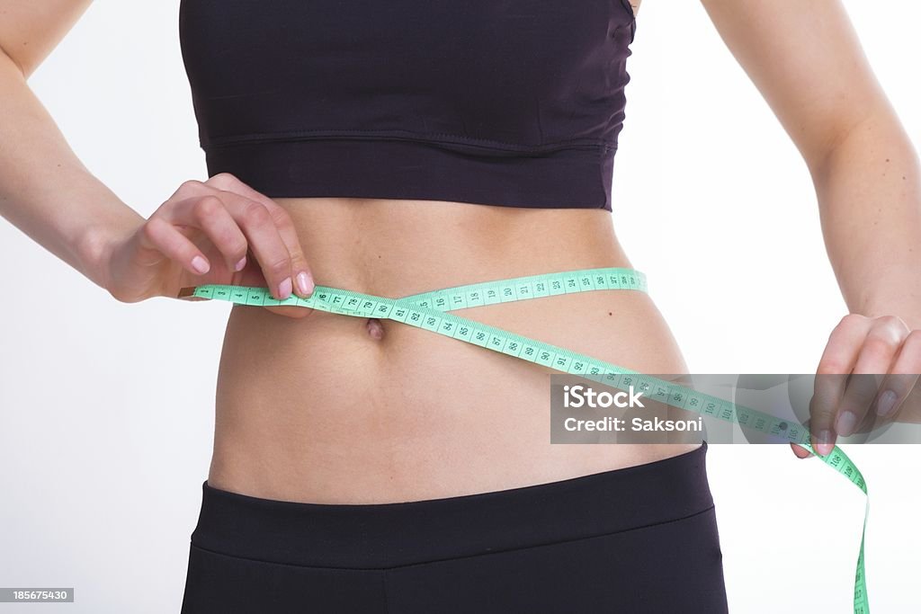 Attractive woman Mid section of sexy young woman with perfect body over white background Abdomen Stock Photo