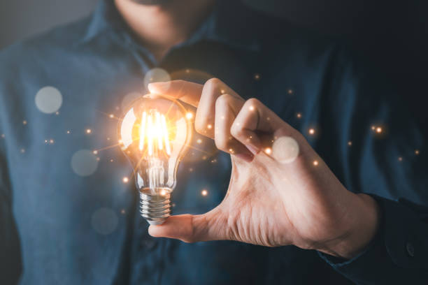 istock Businessman holding light bulb symbolizing creative idea and strategic thinking in business.Creative solution and idea concept. 1856771762