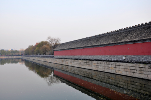 View of the exterior of the boundary red wall surrounding Forbidden City, Beijing, China. Saturation adjusted.