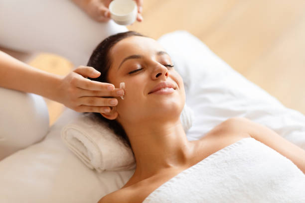 istock Woman Enjoying Relaxing Face Massage While Masseur Applying Moisturizer Indoor 1856803188