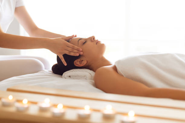 istock Woman Relaxing While Masseur Massaging Temples At Luxury Spa Interior 1856803536