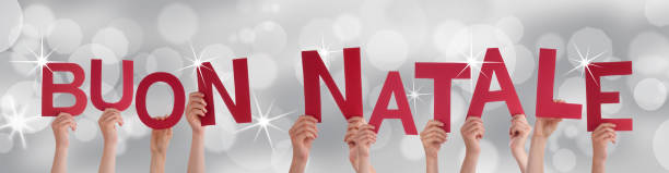 istock People Holding Buon Natale on Silver Backgound 185682472