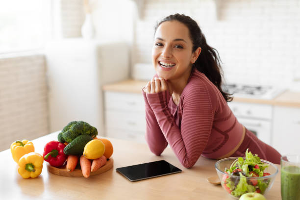 istock Sporty Lady Standing Near Table With Digital Tablet At Kitchen 1856847824