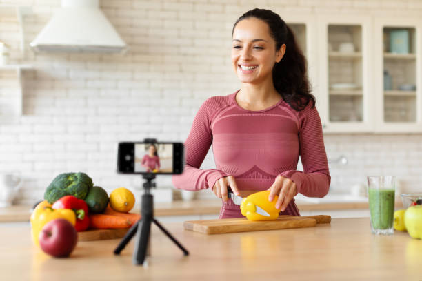 istock Blogger Lady Filming Video Via Smartphone While Cooking At Kitchen 1856848350
