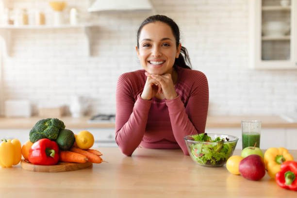 istock Young Fitness Lady Posing At Dining Table In Kitchen Interior 1856848397