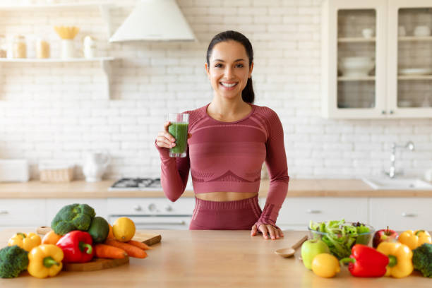 istock Fit woman enjoying freshly made smoothie in her cozy kitchen 1856848403