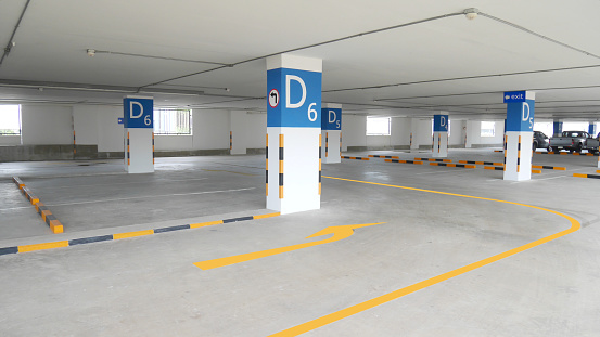 Empty spaces in a modern car park, with fresh paint on the asphalt.