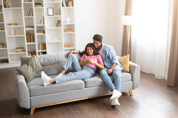 istock Indian couple using cellphone for online shopping. 1856863065