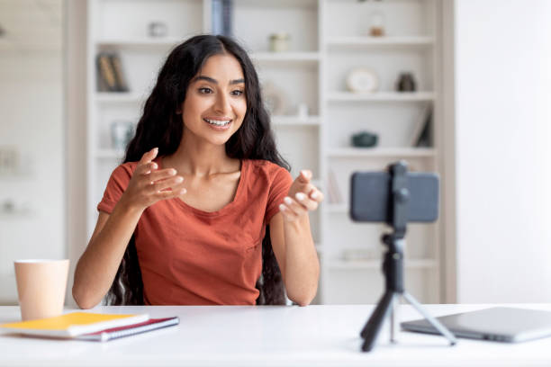 istock Enthusiastic Young Indian Woman Blogger Broadcasting from Home Space 1856879945