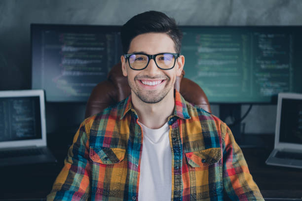 Portrait of positive clever server optimization expert sitting chair operate research netbook pc display desktop office indoors