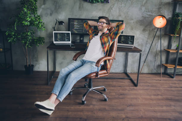 istock Full size photo of satisfied positive front end developer sit chair hands behind head accomplish tasks workstation modern office indoors 1856893246