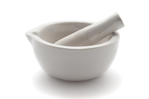 Close-up of white Ceramic Mortar and Pestle over a white background.