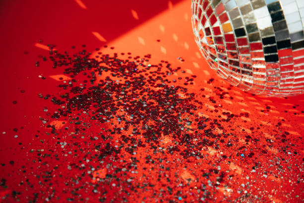 istock Christmas greeting background with empty space. Red sparkle Christmas toys and sequins on a red background 1856903351