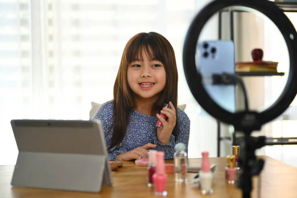istock Smiling young Asian girl creating a make up tutorial video content for social media 1856924028