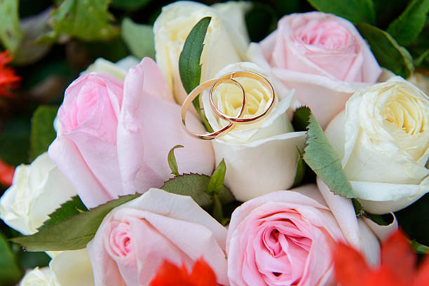 istock Wedding rings on a bouquet of roses 185692450