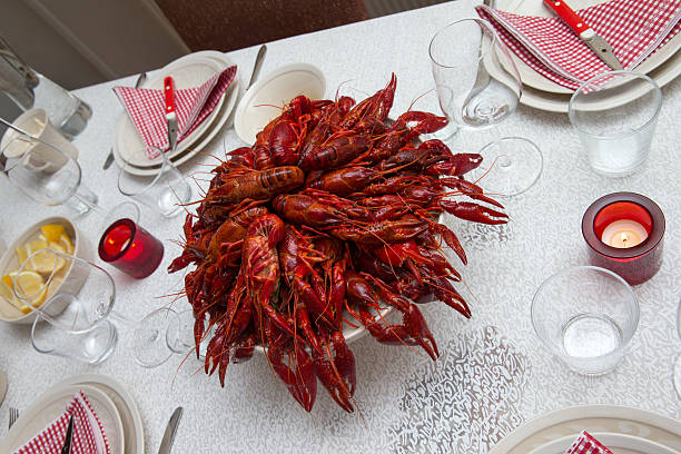 Boiled crayfish with spices in salt with foamy beer for a snack.