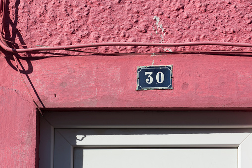 Portal of a house with the number 30 on its facade