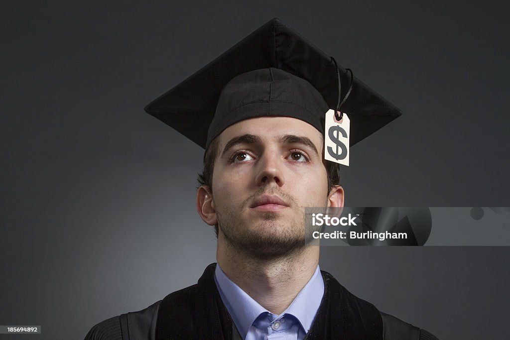 College graduate with tuition price tag on mortarboard, horizontal Recent college graduate with tuition debt, horizontal Graduation Stock Photo