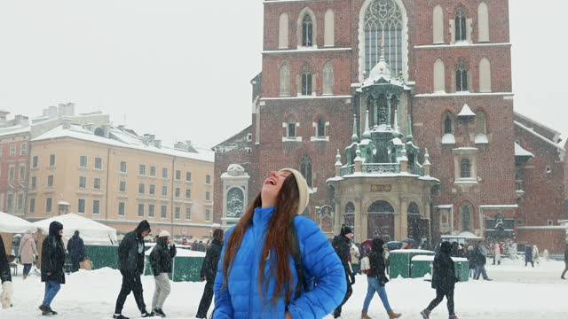 Happy Woman with Backpack Contemplating Snowy Christmas Time in Krakow